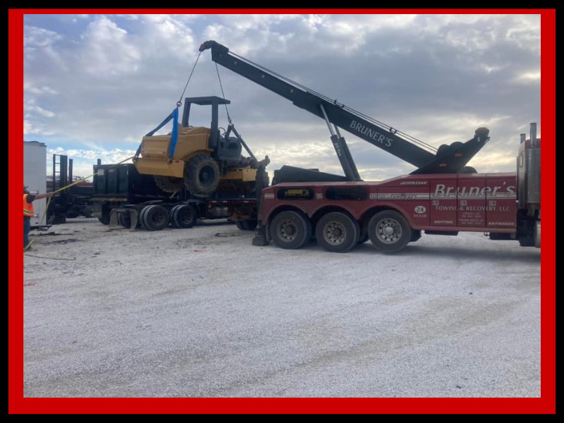 truck towing a piece of heavy equipment